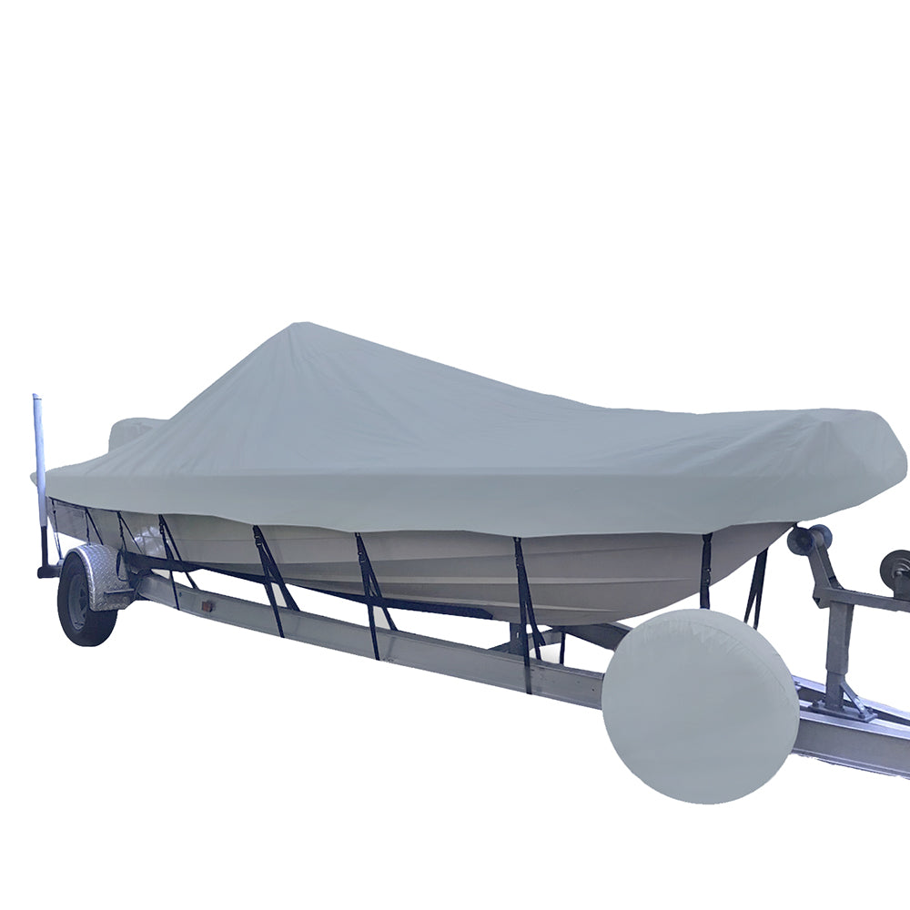 A boat sits on a trailer with a white cover on the boat. 